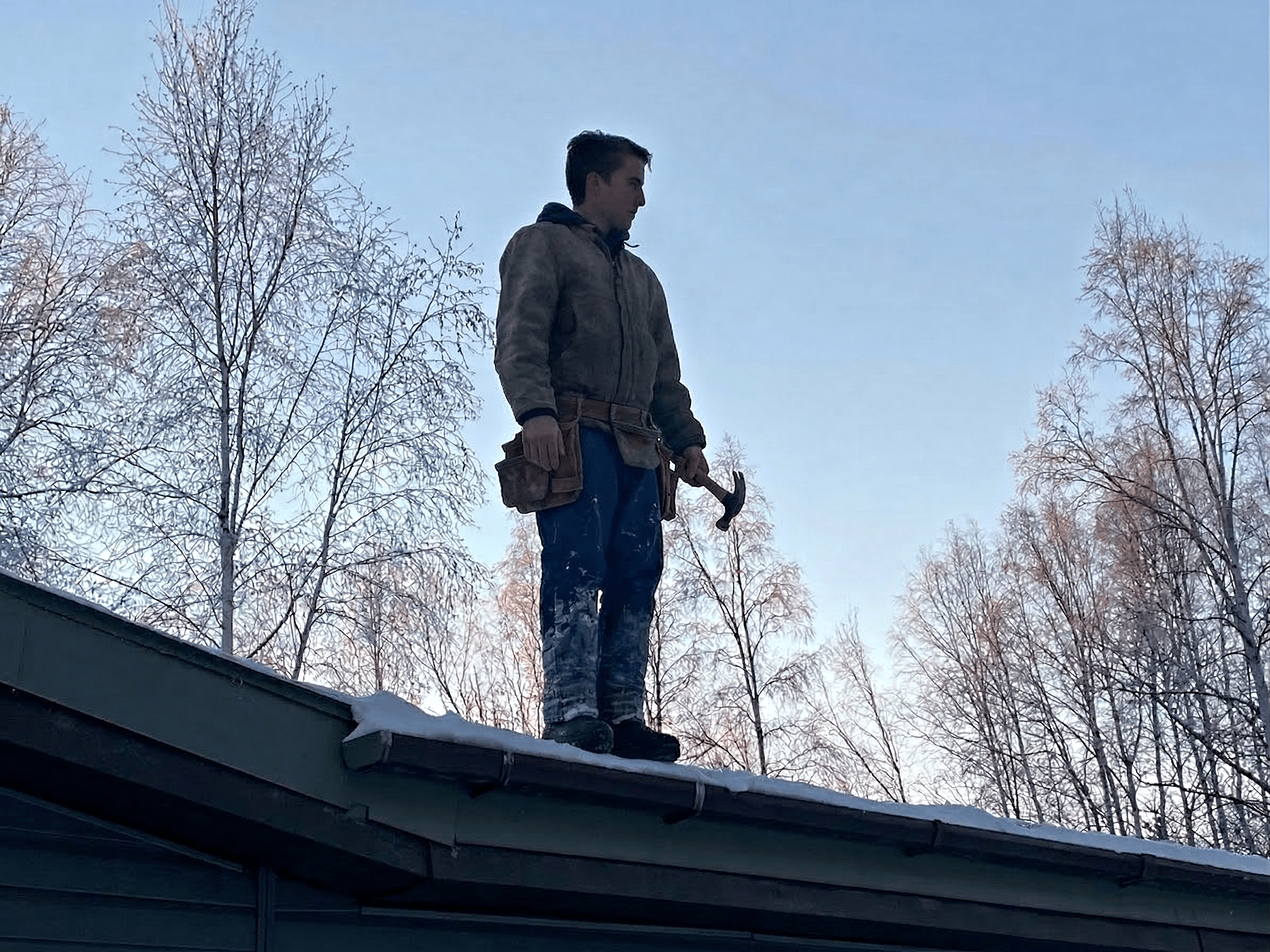 Maintenance work on roof in Alaska winter